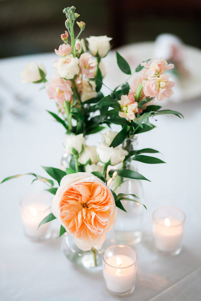 Beautiful peach, green and white centerpiece at wedding in Wilmington NC.