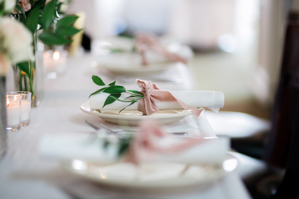 Table setting at reception for wedding at Airlie Gardens.