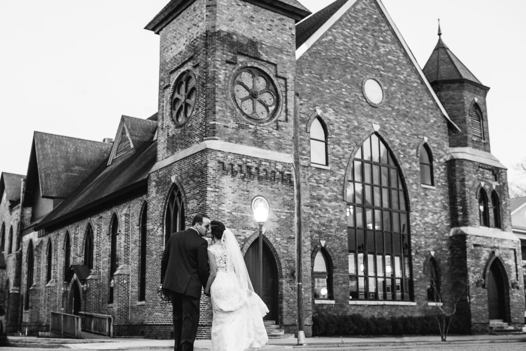 Newly married couple kisses outside of the Brooklyn Arts Center in Downtown Wilmington NC.