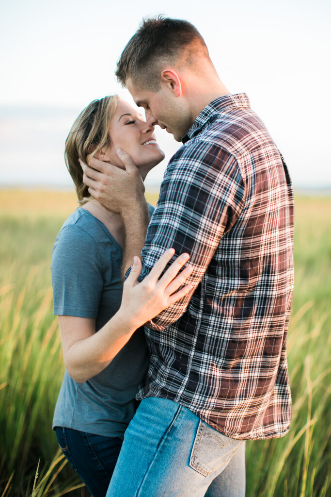 Engaged couple kisses during their engagement session photographs on Bald Head Island NC.