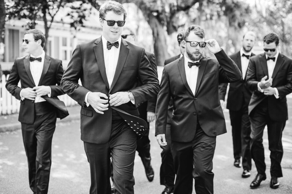 Groom and groomsmen walk together towards his wedding ceremony.