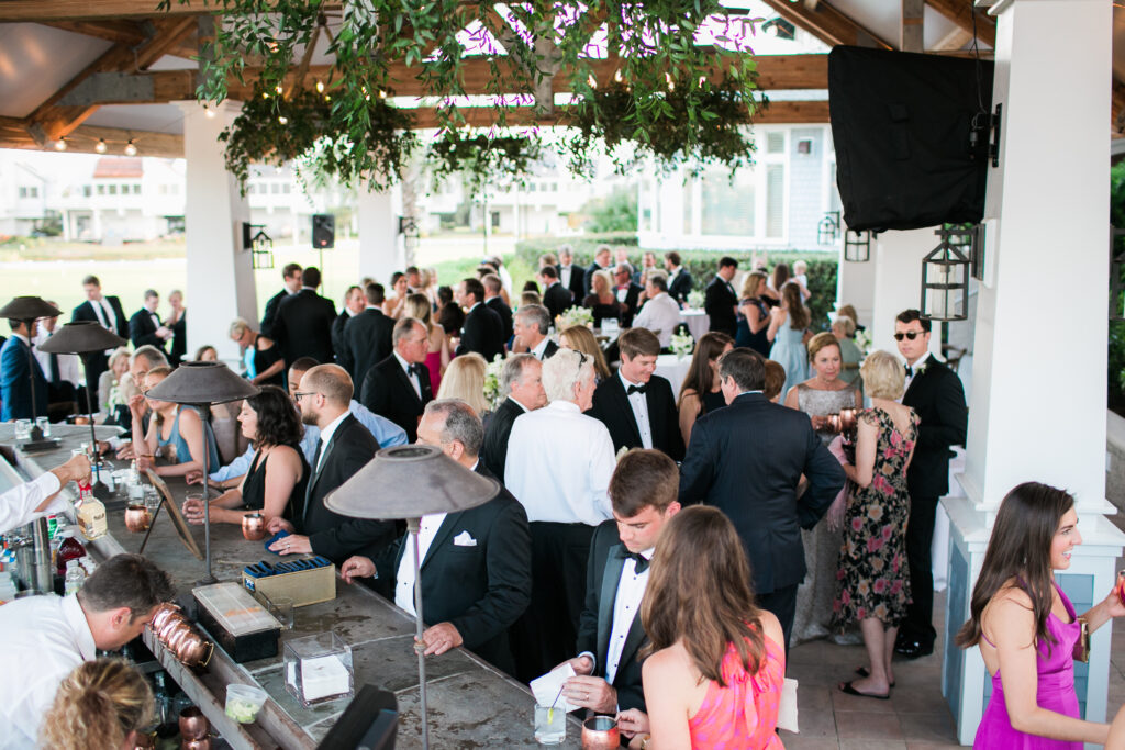 Wedding guests mingle as they wait for the bride and groom to get back from taking photographs.