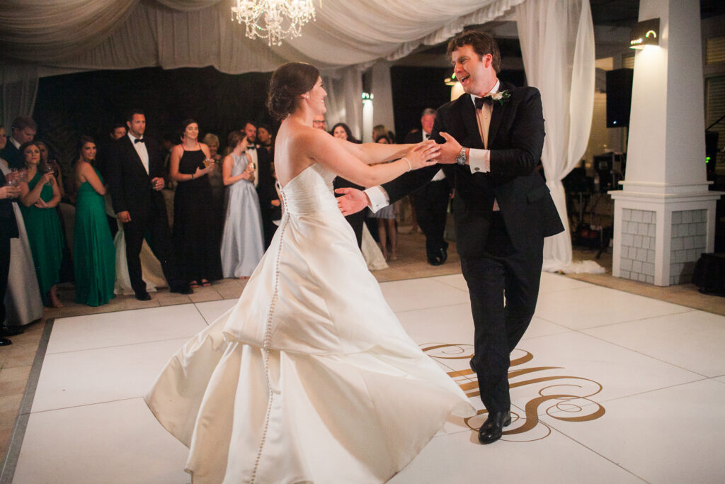 Bride and groom dance on dance floor during their wedding reception at Bald Head Island.