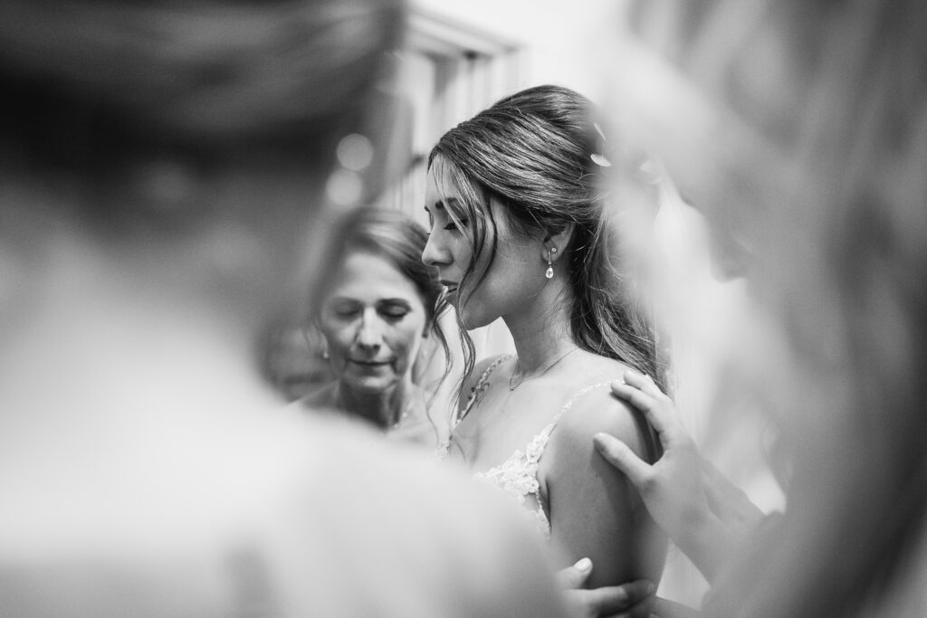 A bride and her family say a final prayer before she walks down the aisle at her Brooklyn Arts Center Wedding in Wilmington NC.