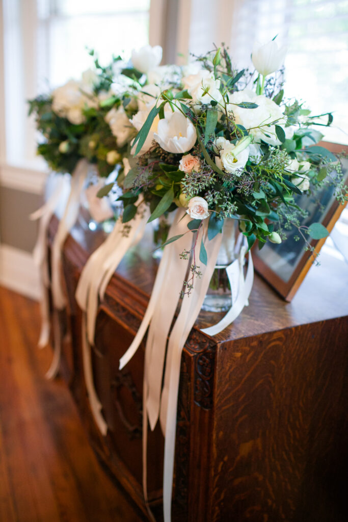 Beautiful wedding bouquet at the Brooklyn Arts Center in Wilmington NC. Whites and greens with pink ribbon.