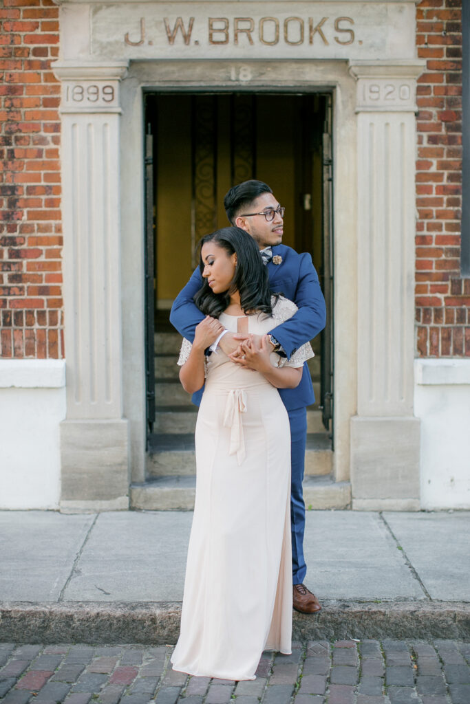 Engaged couple hugs during downtown wilmington nc engagement session.