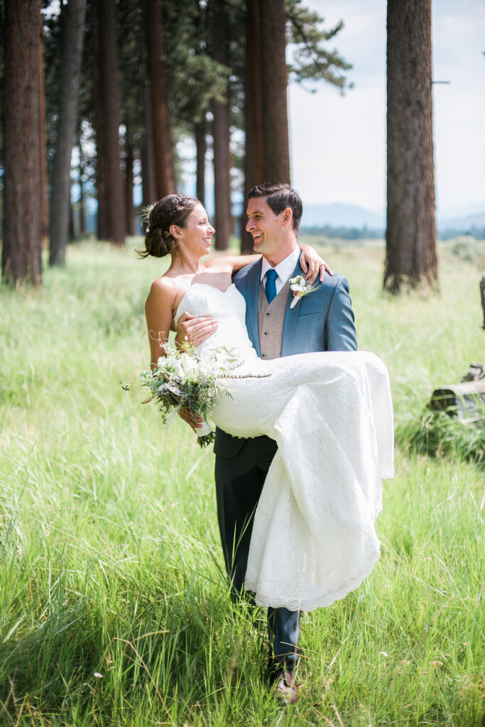 Bride and groom walk through meadow in South Lake Tahoe after their wedding.