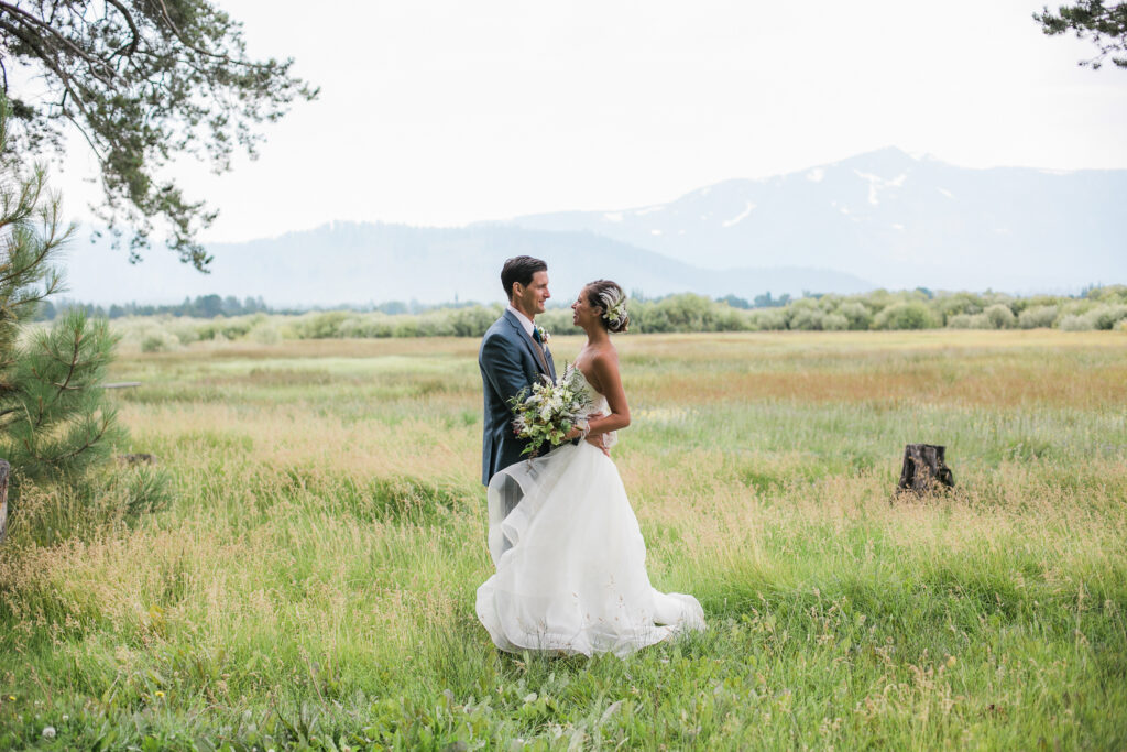 Bride and groom hug in South Lake Tahoe with Mt. Tallac in the background of their wedding.