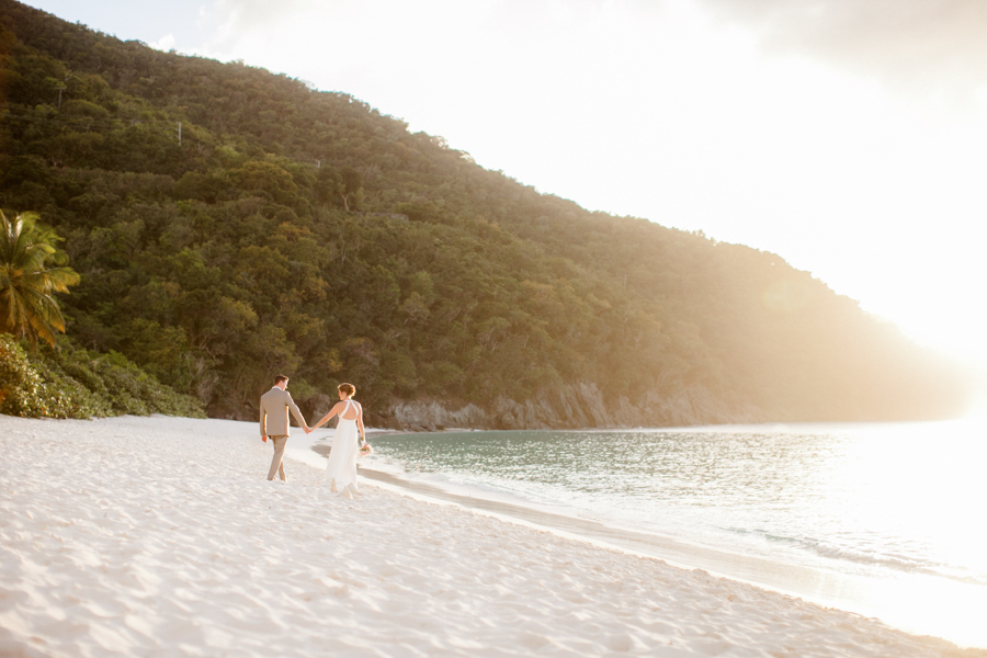 Bride and groom walk along Trunk Bay after their St. John USVI Wedding.