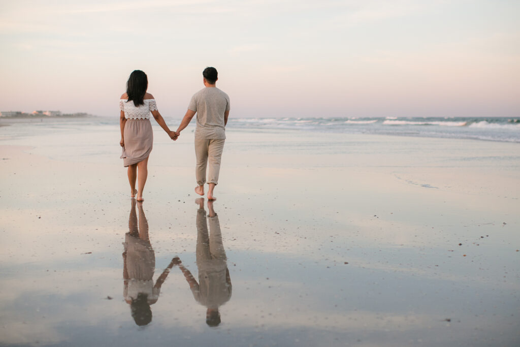 engaged couple on beach takes photo during wrightsville beach engagement session.