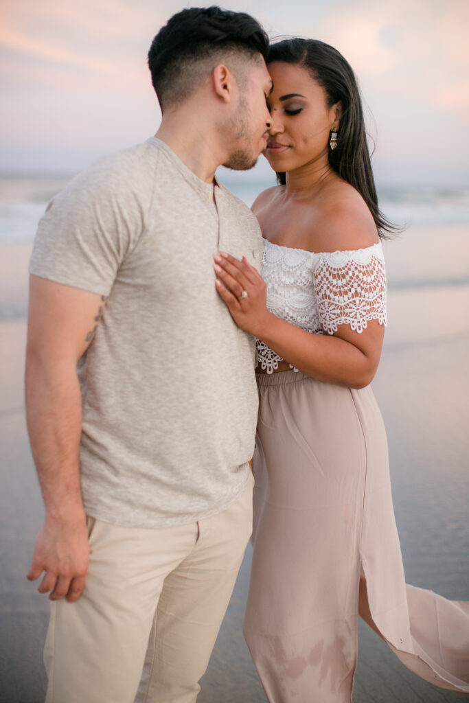 engaged couple on wrightsville beach nc, taking engagement session photos.