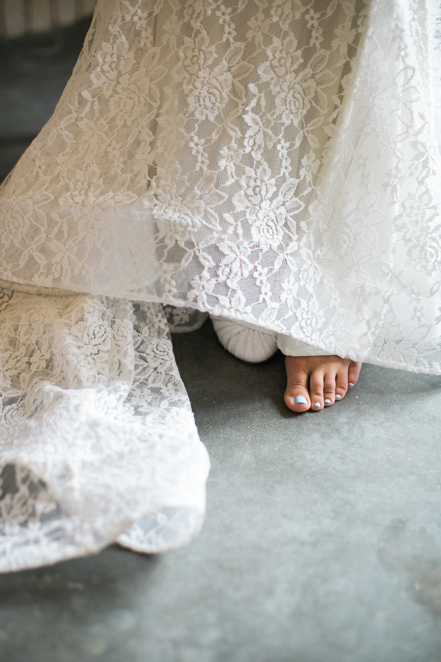 The edge of a brides dress with only her toes showing in a Wilmington NC wedding.