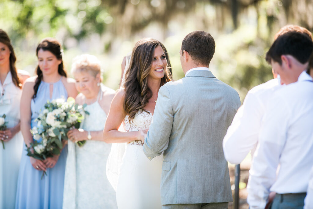 A bride and groom exchange rings during their Airlie Gardens ceremony.