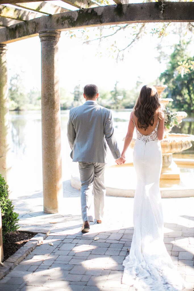 A bride and groom walk away from the camera during their airlie gardens wedding photography.