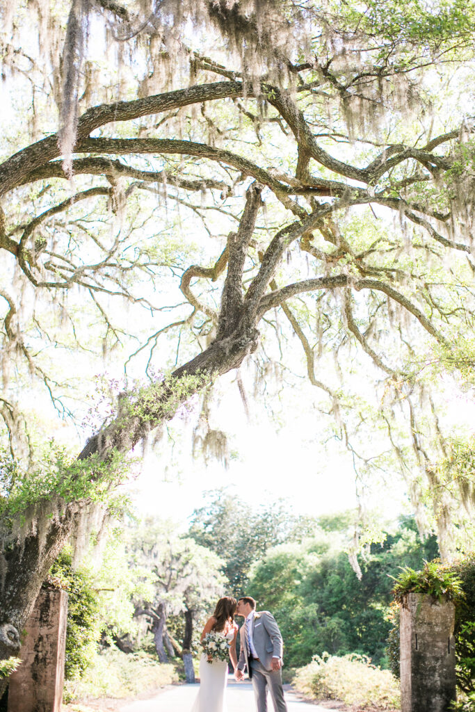 Bride and groom take photographs after their wedding at Airlie Gardens