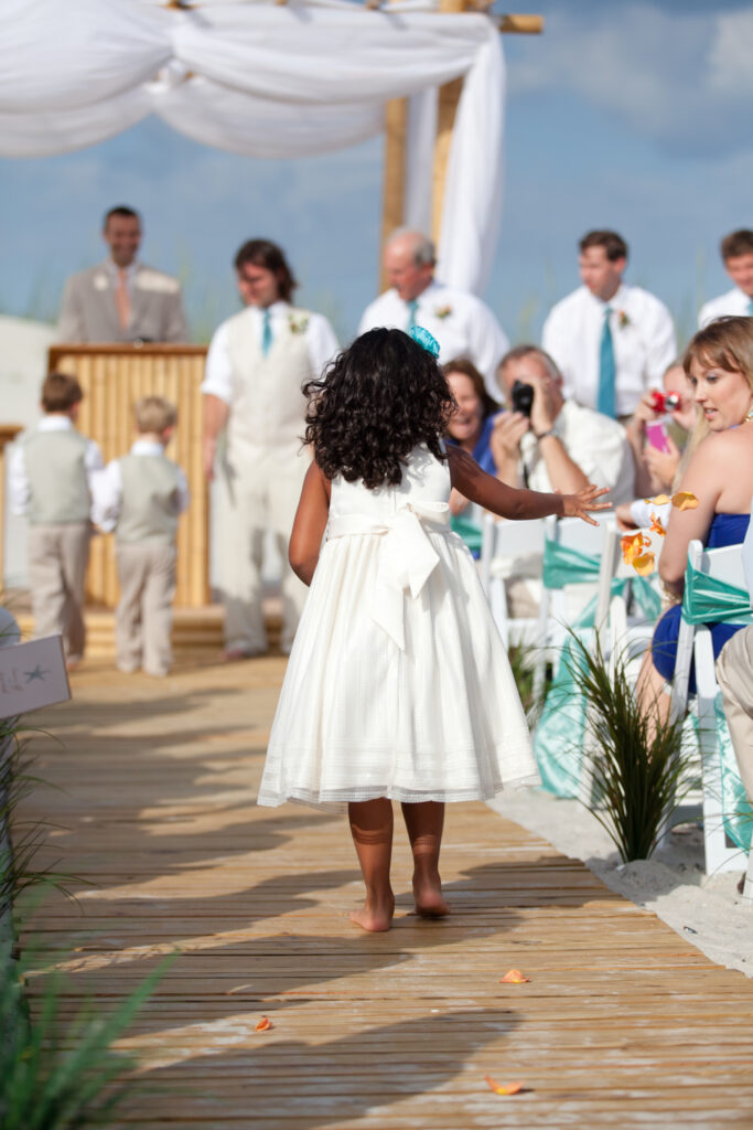 Flower girl at Shell Island Resort wedding throws flowers