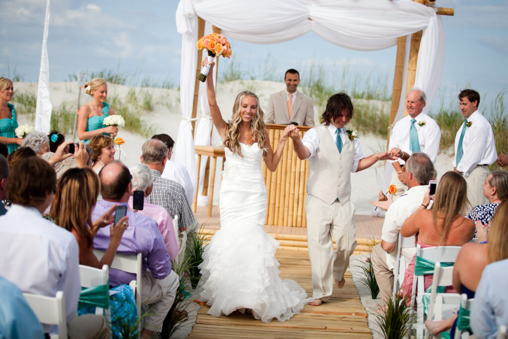 Bride and groom walk down the aisle after their Shell Island Resort wedding.