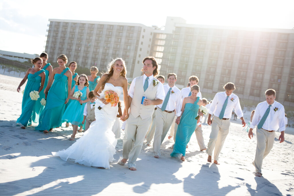 The wedding party celebrates after a Shell Island Resort wedding on Wrightsville Beach NC